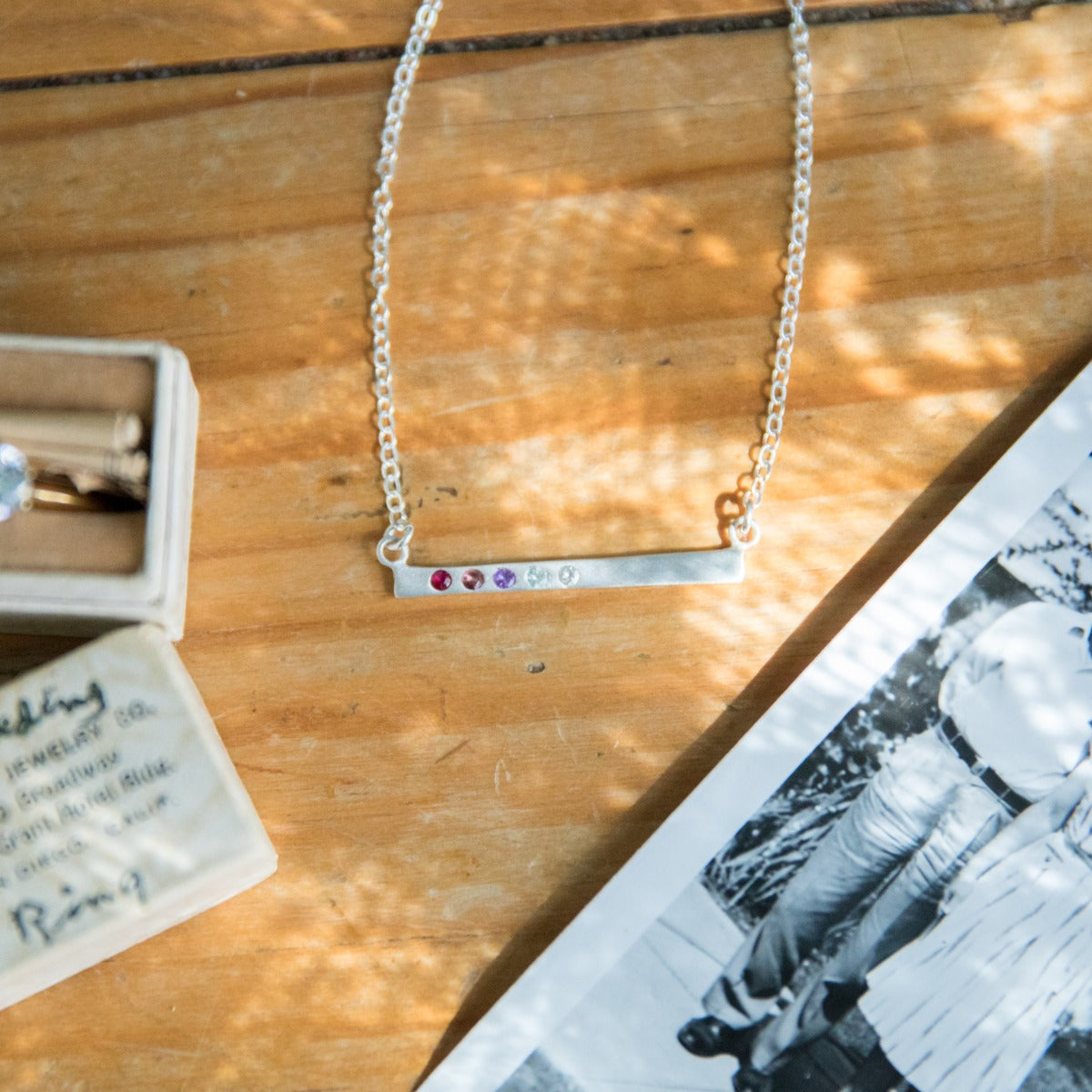 sterling silver cross bar birthstone necklace strung on a silver link chain customizable with up to 7 genuine 2mm birthstones 