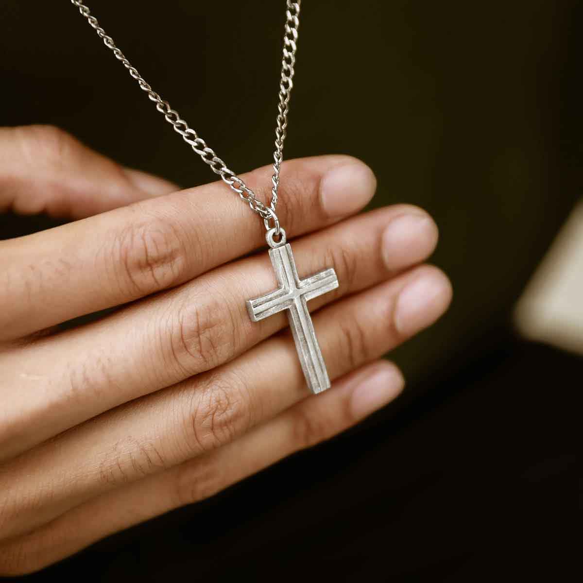 man wearing a pewter Adopted Cross Necklace