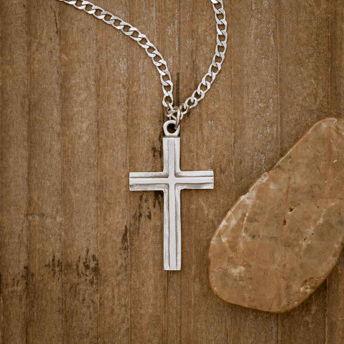 pewter Adopted Cross Necklace, on wood background