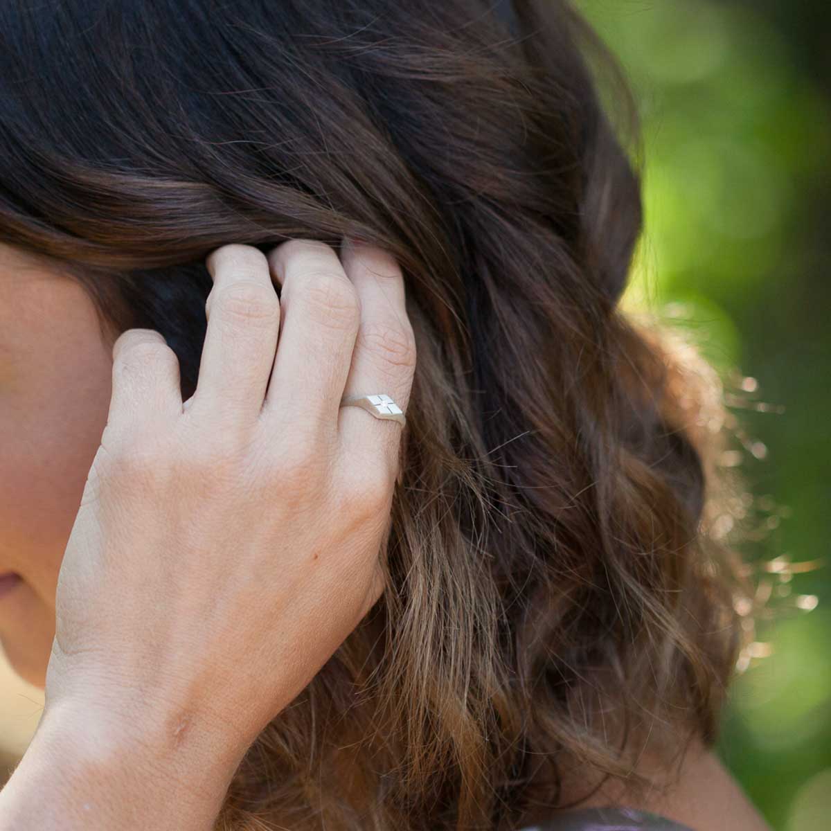 Girl wearing Adored ring hand-molded and cast in sterling silver set with a 2mm genuine diamond 