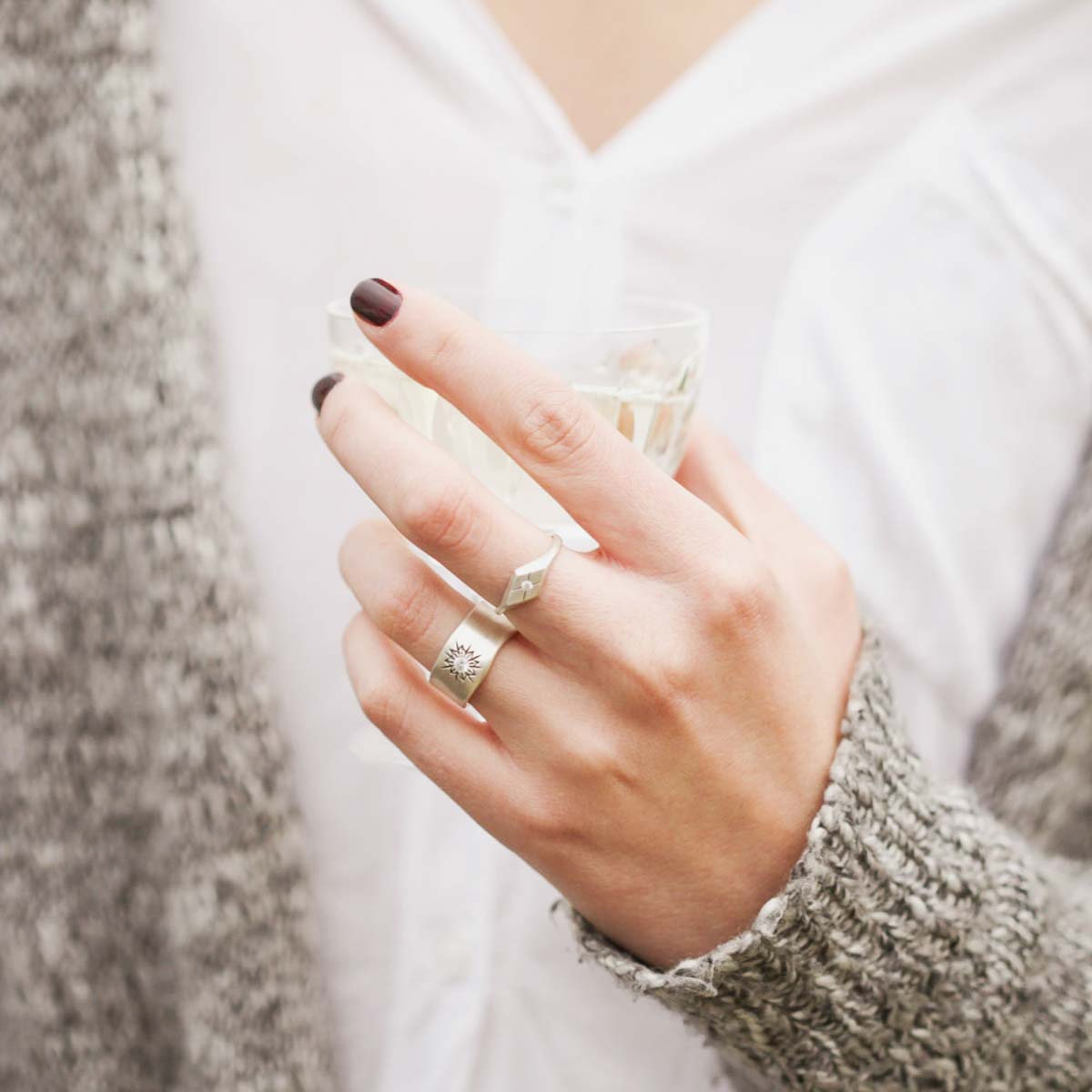 Girl wearing Adored ring hand-molded and cast in sterling silver set with a 2mm genuine diamond along with other sterling silver jewelry