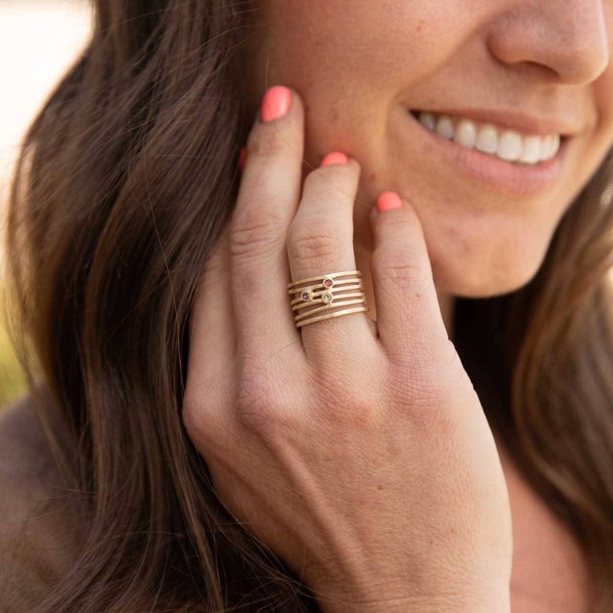 Woman wearing Always together birthstone ring handcrafted in 10k yellow gold set with 3 to 6 birthstones