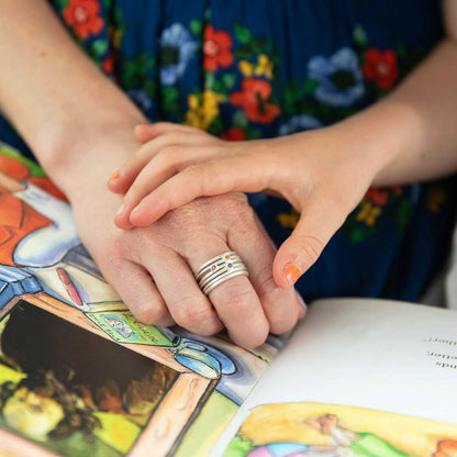 Woman wearing Always together birthstone ring handcrafted in sterling silver set with 3 to 6 birthstones with her children