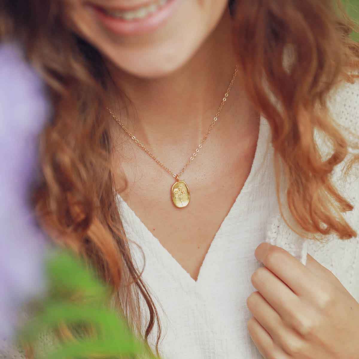 girl wearing a gold plated April birth flower necklace with an 18" gold filled link chain