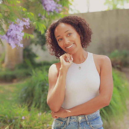 girl wearing a sterling silver April Birth flower necklace