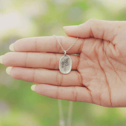 girl wearing a pewter April Birth Flower necklace with 18" link chain