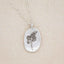 sterling silver April Birth flower necklace, on beige background