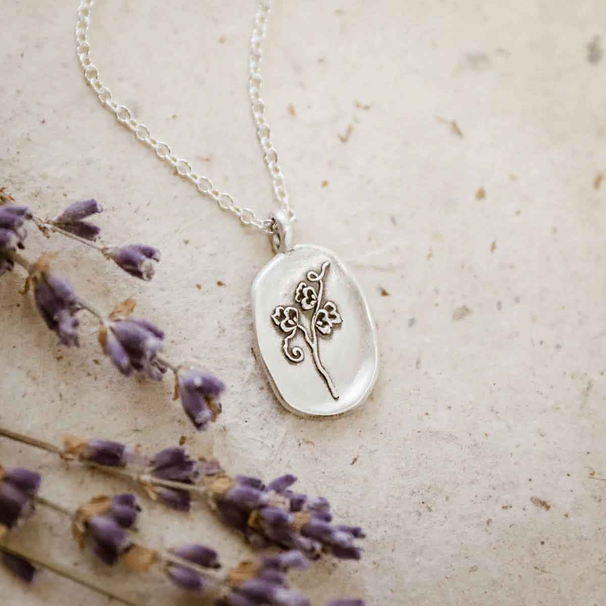 girl wearing a sterling silver April Birth flower necklace