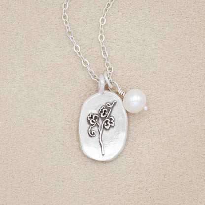 April birth flower necklace handcrafted in sterling silver with a special birth month charm strung with a vintage freshwater pearl