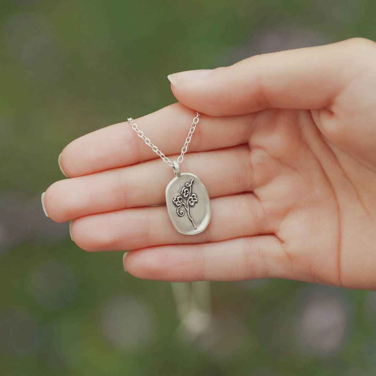 girl holding a sterling silver April