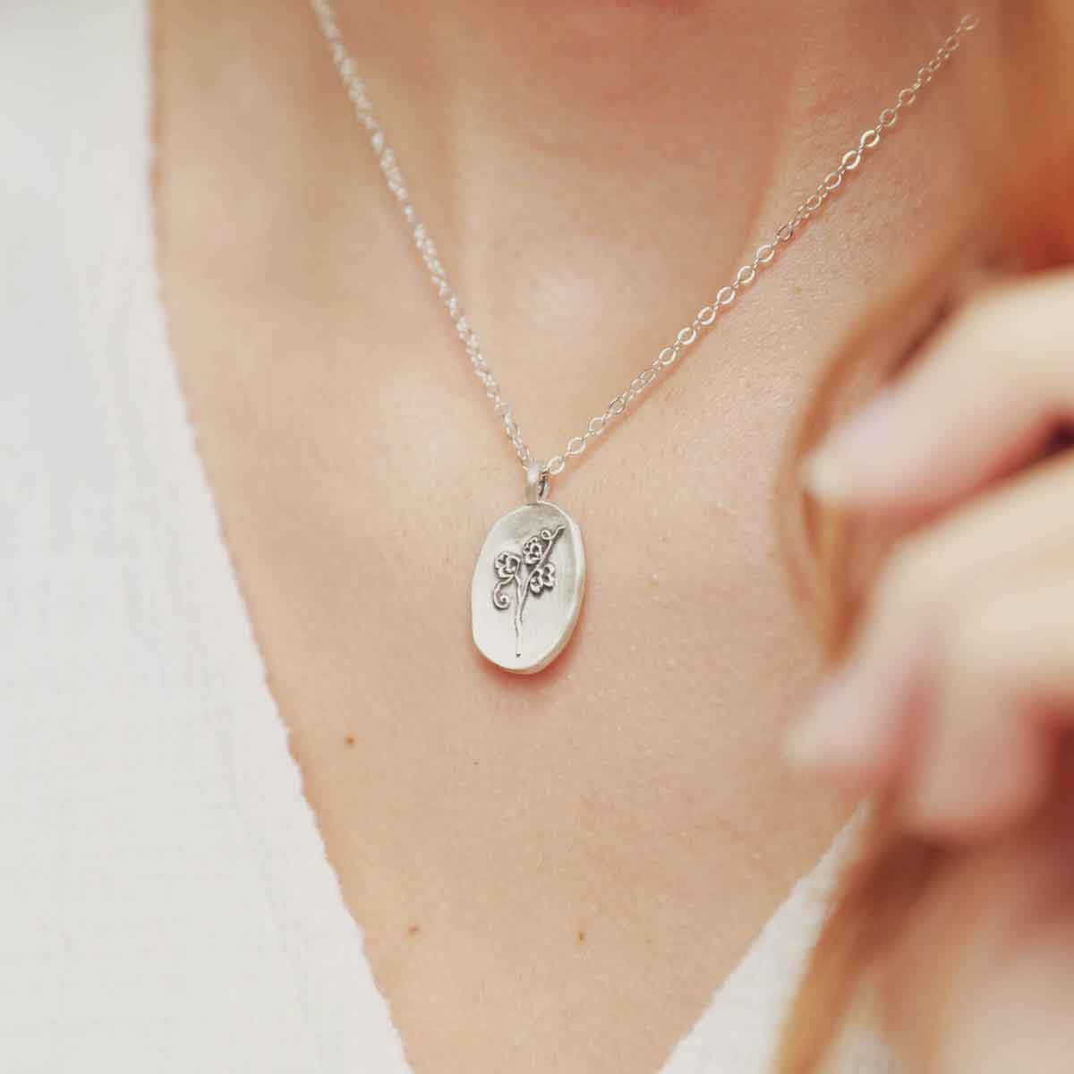 girl wearing a sterling silver April Birth flower necklace