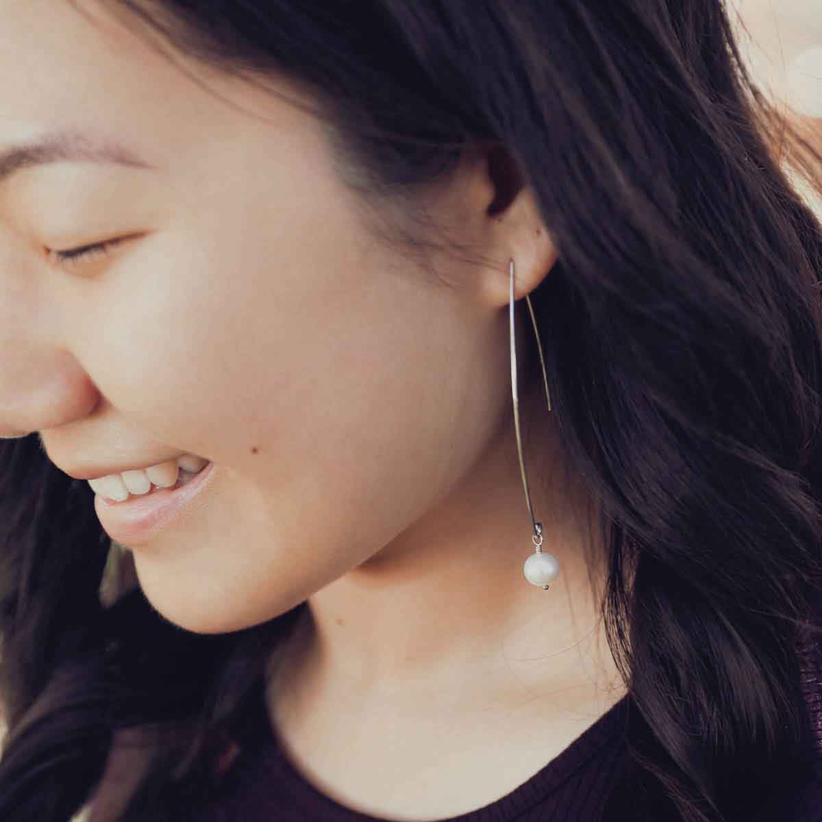 girl wearing sterling silver artisan pearl earrings