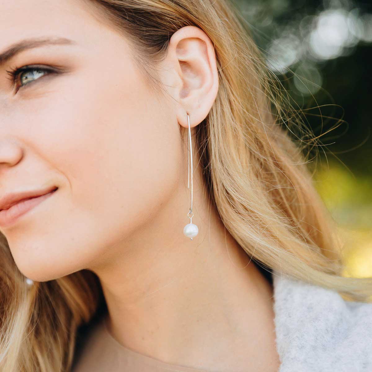 girl wearing sterling silver artisan pearl earrings