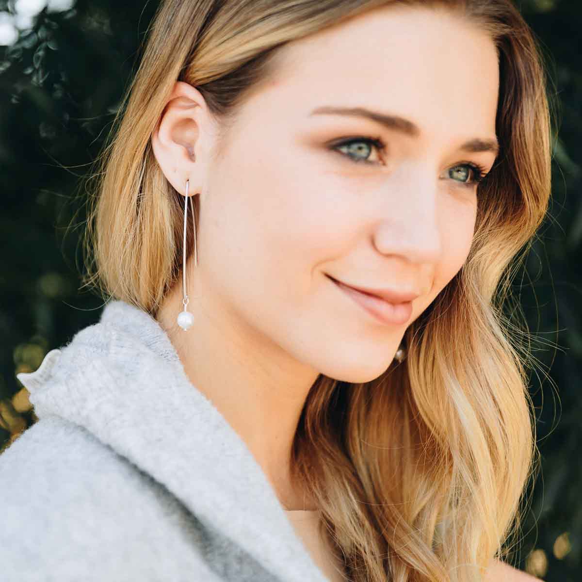 girl wearing sterling silver artisan pearl earrings