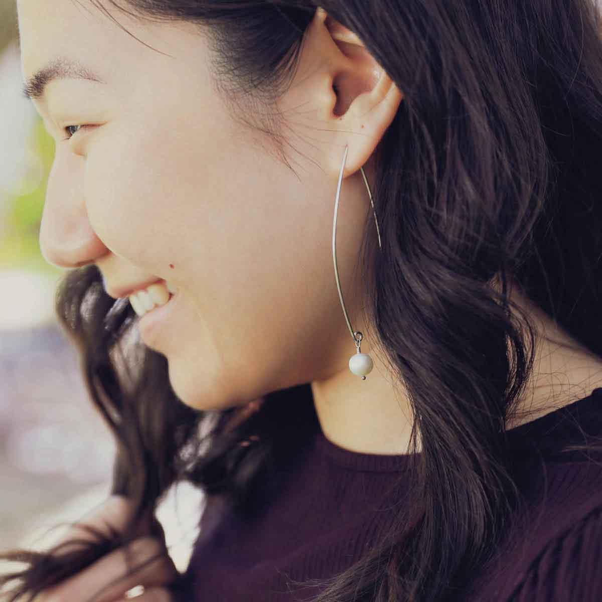 girl wearing sterling silver artisan pearl earrings