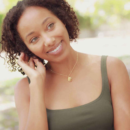 girl wearing a gold plated August birth flower necklace with an 18" gold filled link chain