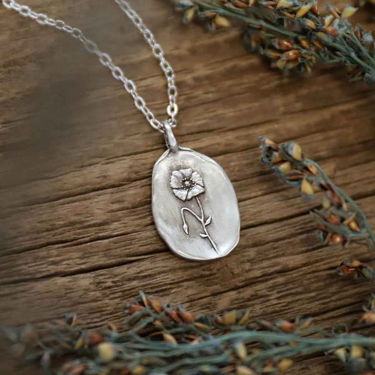 girl wearing a pewter August Birth Flower necklace with 18" link chain