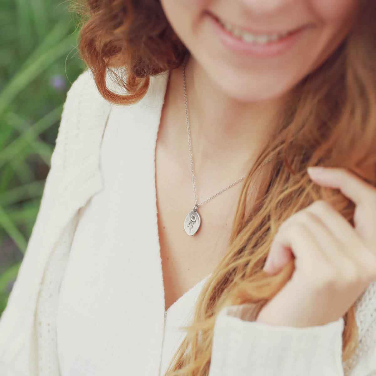 girl wearing a pewter August Birth Flower necklace with 18" link chain