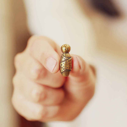 a gold plated baby jesus nativity figurine in a pewter manger