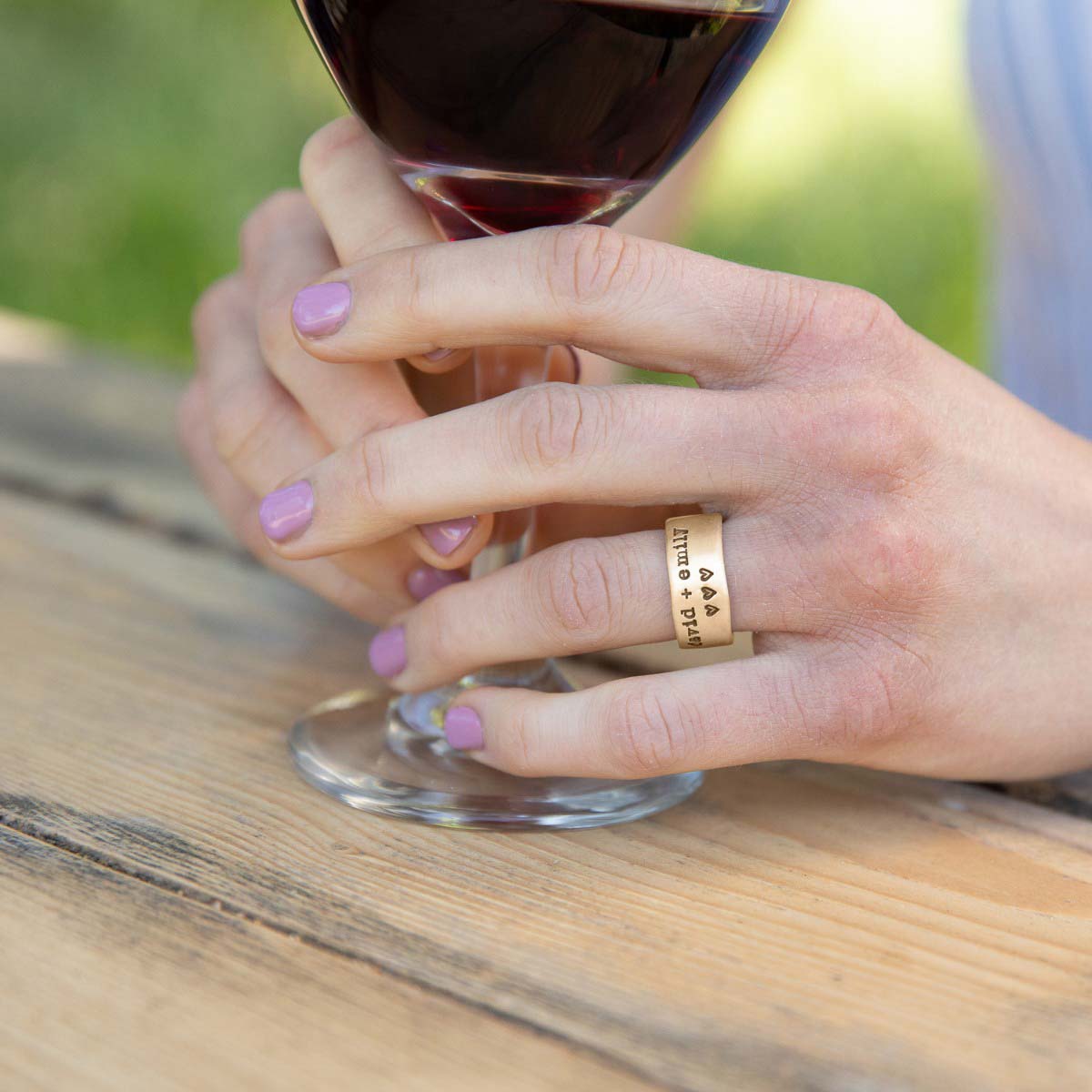 Girl wearing Band together ring handcrafted in 10k yellow gold with an antiqued/satin finish and personalized with words