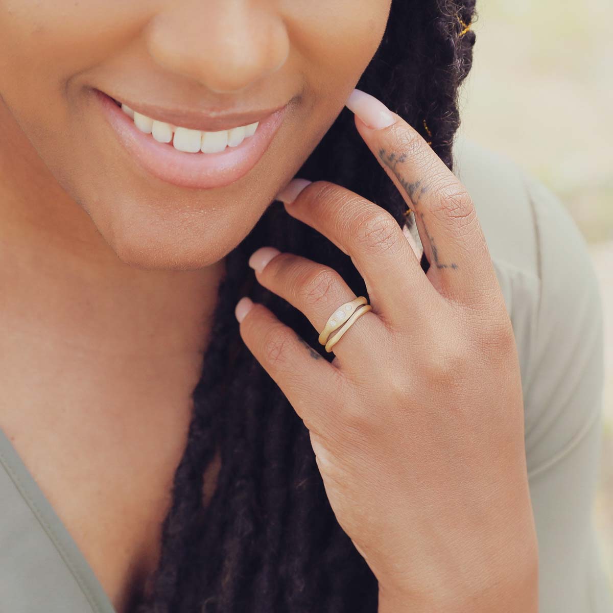 Girl wearing Be mine ring pair hand-molded and cast in 10k yellow gold set with a 3mm birthstone or a diamond 