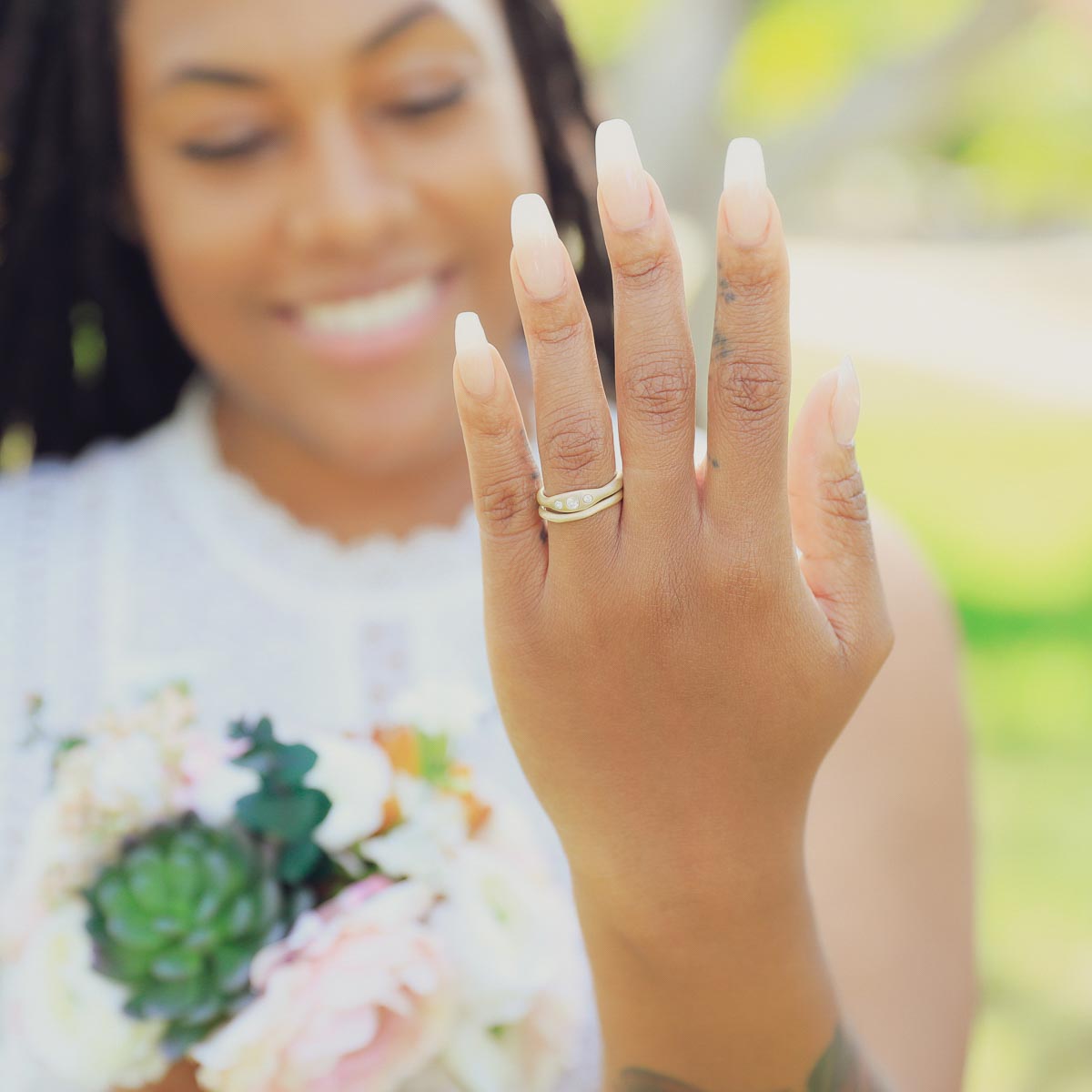 Woman wearing Be mine ring pair hand-molded and cast in 14k yellow gold set with a 3mm birthstone or a diamond 