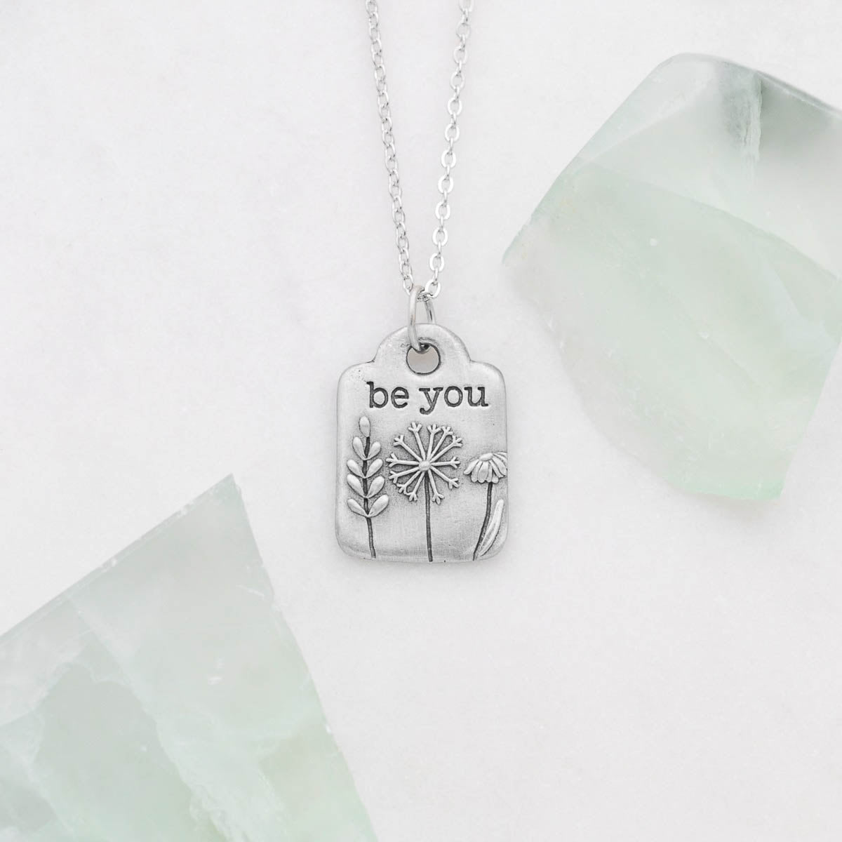 Be you necklace handcrafted in pewter hung on a silver-toned link chain with the words "be you" engraved