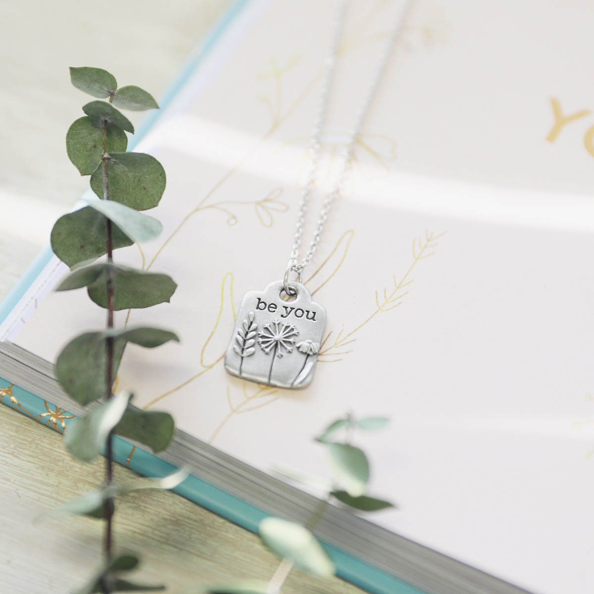 Be you necklace handcrafted in pewter hung on a silver-toned link chain with the words "be you" engraved