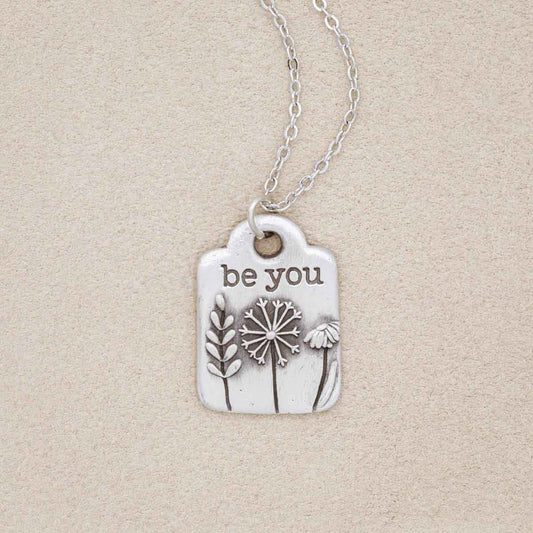 Be you necklace handcrafted in pewter hung on a silver-toned link chain with the words "be you" engraved