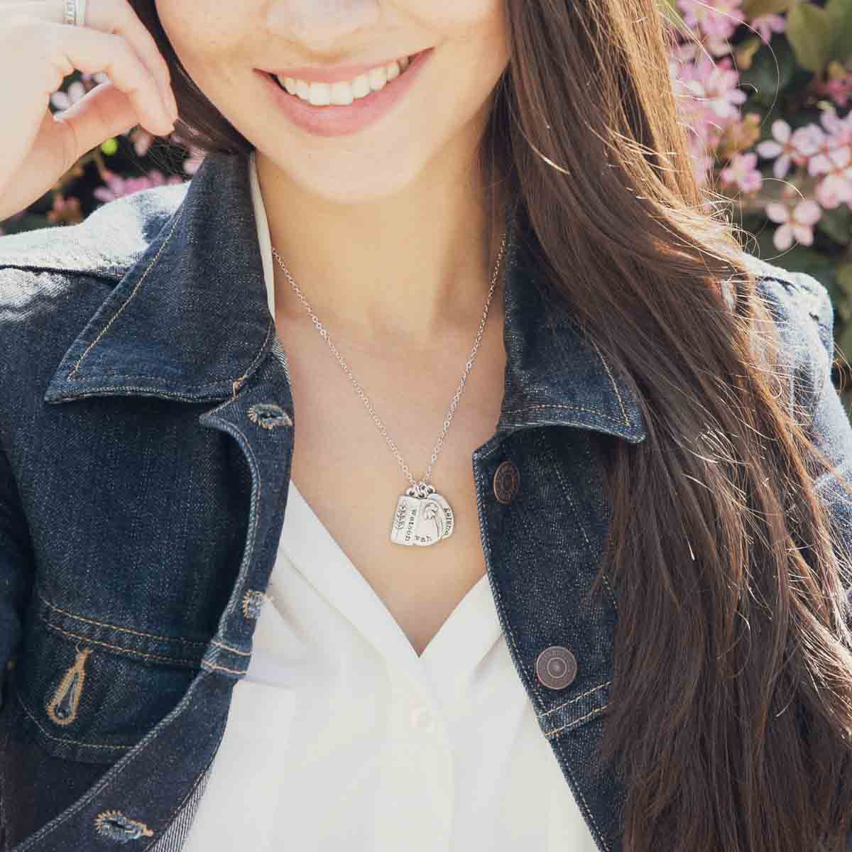 Girl wearing her Personalized sterling silver be you wildflowers necklace with 3 sterling silver charms