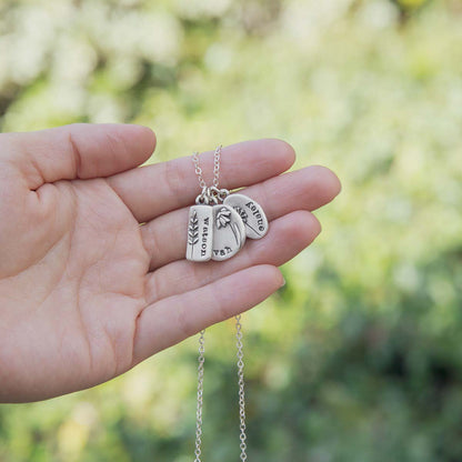 Personalized sterling silver be you wildflowers necklace with 3 sterling silver charms on display