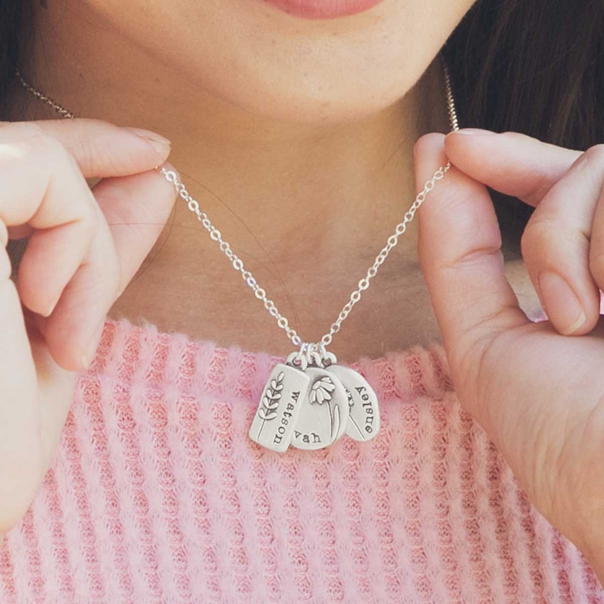 Girl wearing her Personalized sterling silver be you wildflowers necklace with 3 sterling silver charms