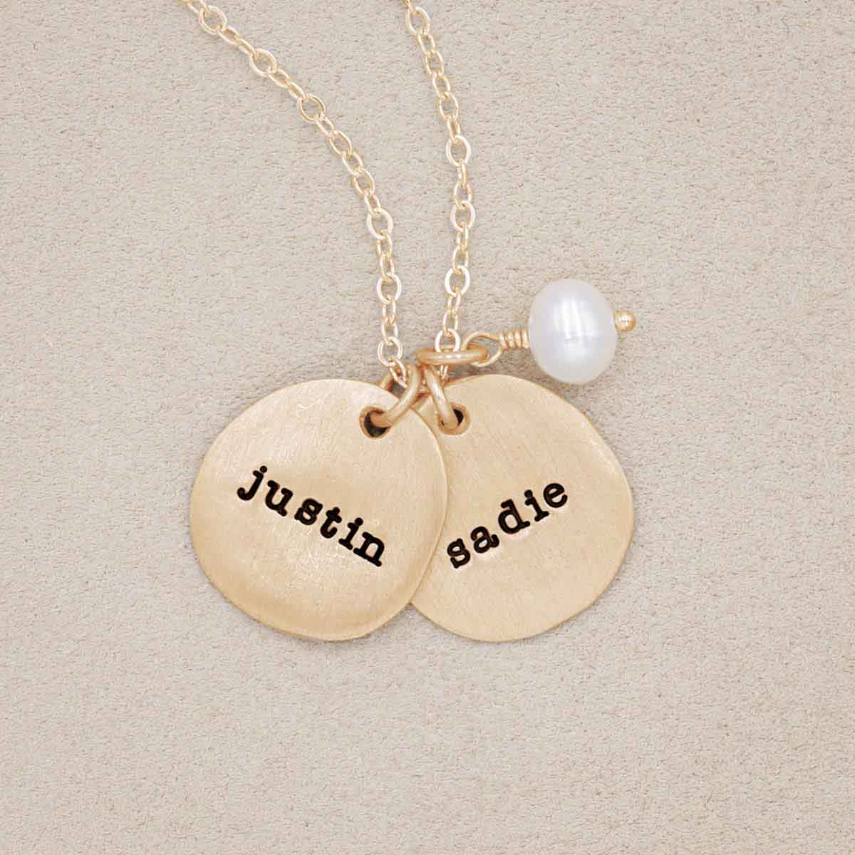 Beloved name disc handcrafted in 14k yellow gold hung with a vintage freshwater pearl and customizable with a name or word along with other sterling silver jewelry