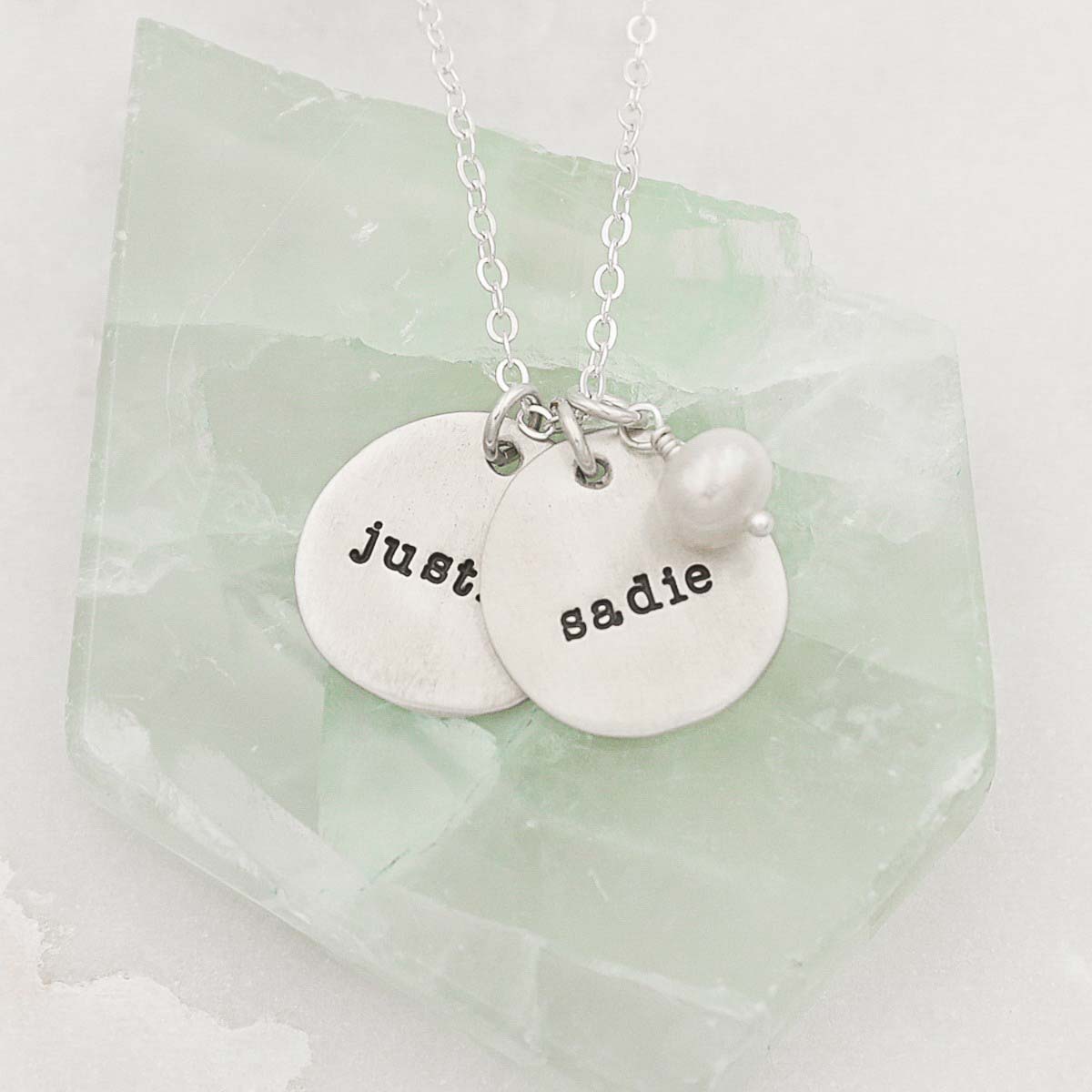 Beloved name disc handcrafted in sterling silver hung with a vintage freshwater pearl and customizable with a name or word