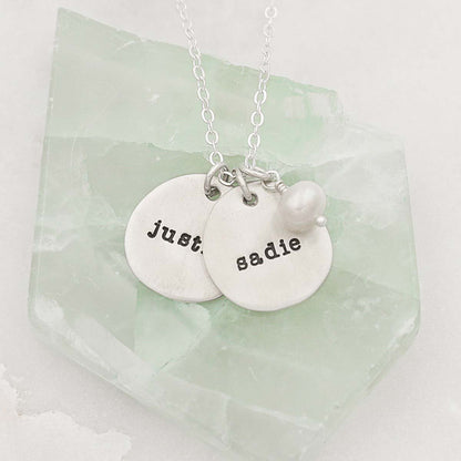 Beloved name disc handcrafted in sterling silver hung with a vintage freshwater pearl and customizable with a name or word