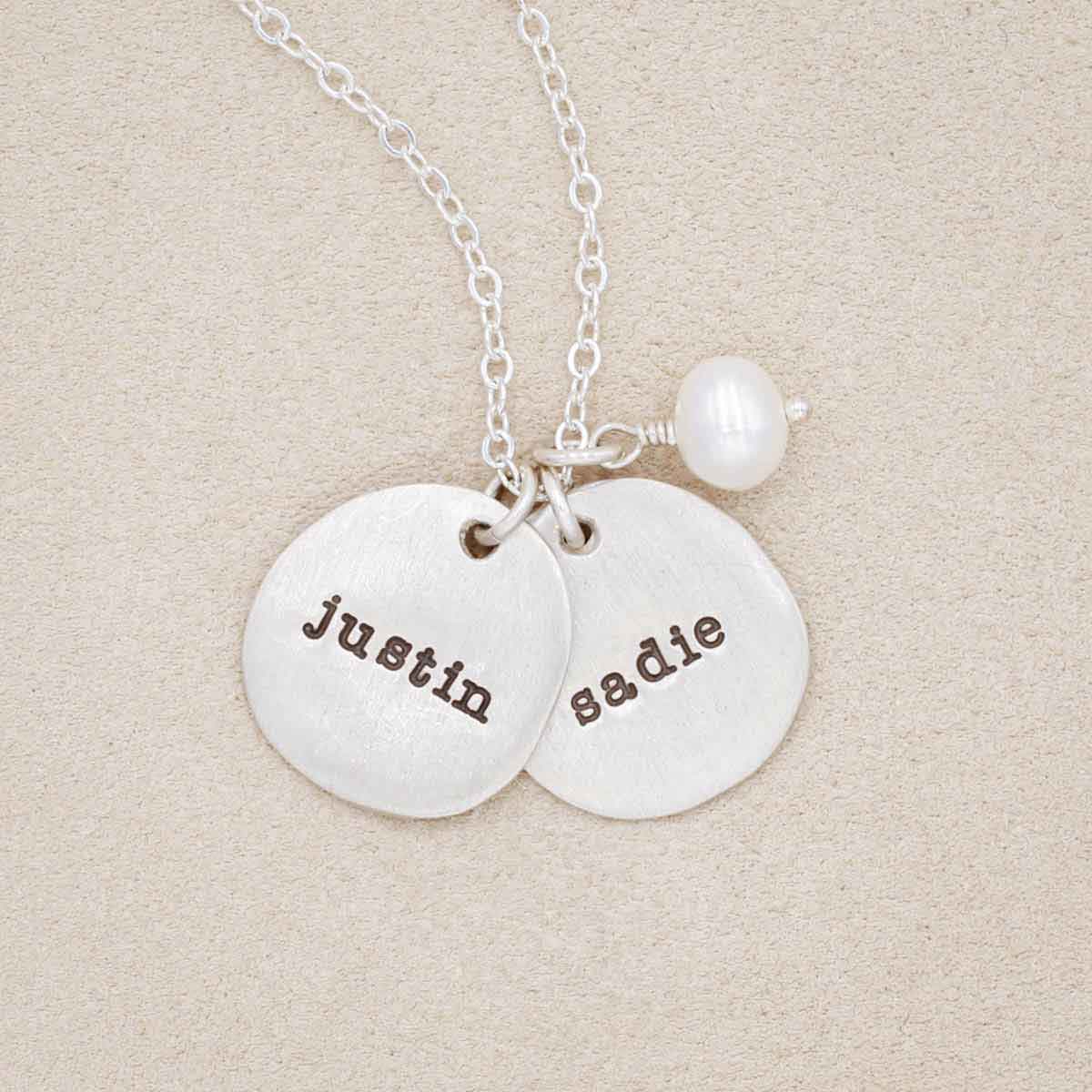 Beloved name disc handcrafted in sterling silver hung with a vintage freshwater pearl and customizable with a name or word