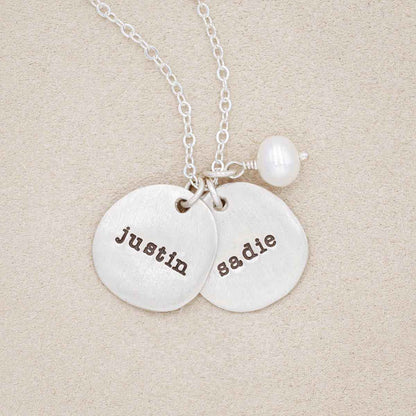 Beloved name disc handcrafted in sterling silver hung with a vintage freshwater pearl and customizable with a name or word