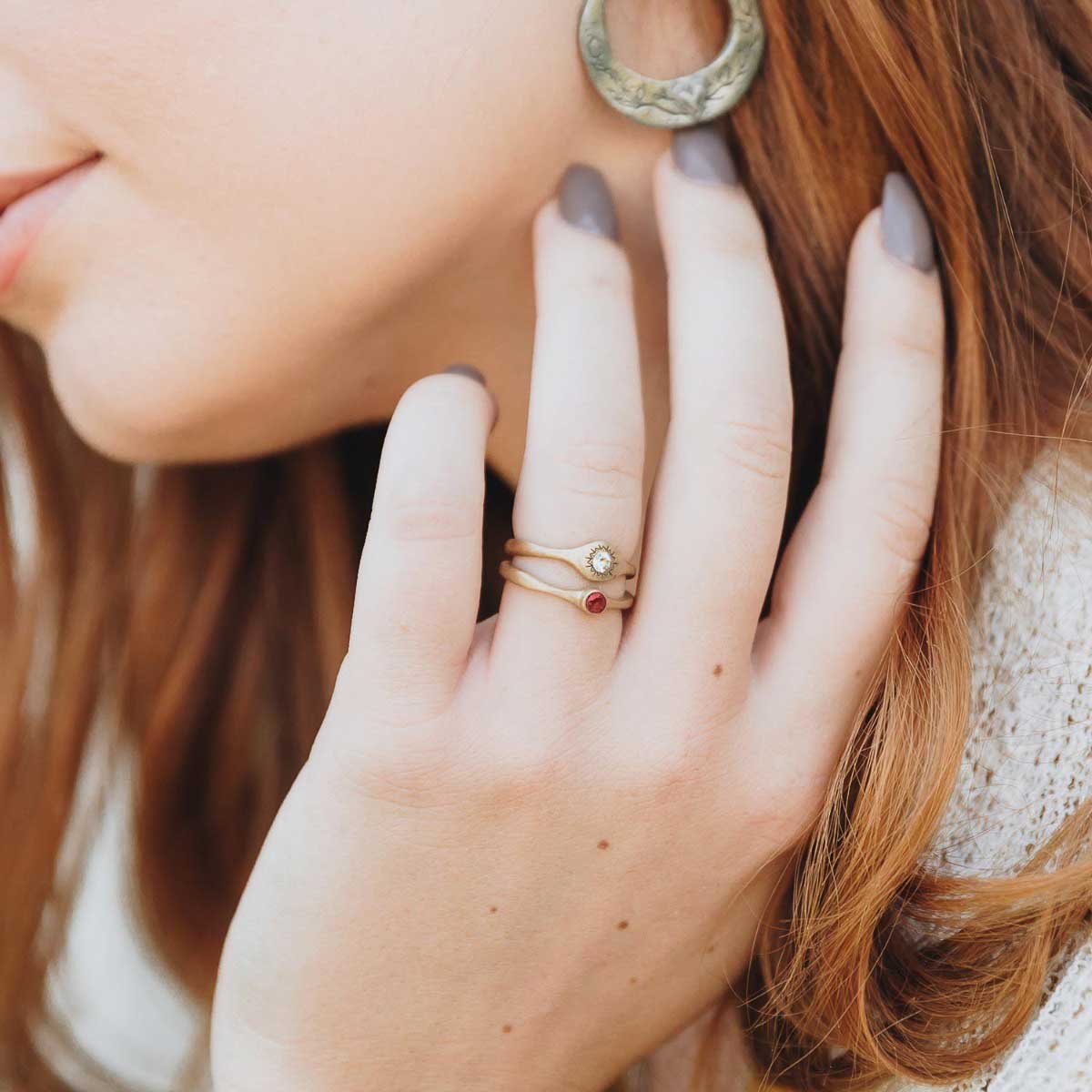 Girl wearing Bezel birthstone ring handcrafted in 10k yellow gold set with a 3mm birthstone inside a gold bezel