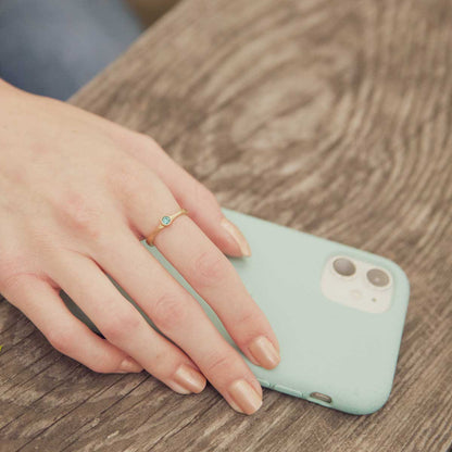 Girl wearing Bezel birthstone ring handcrafted in 14k yellow gold set with a 3mm birthstone inside a gold bezel