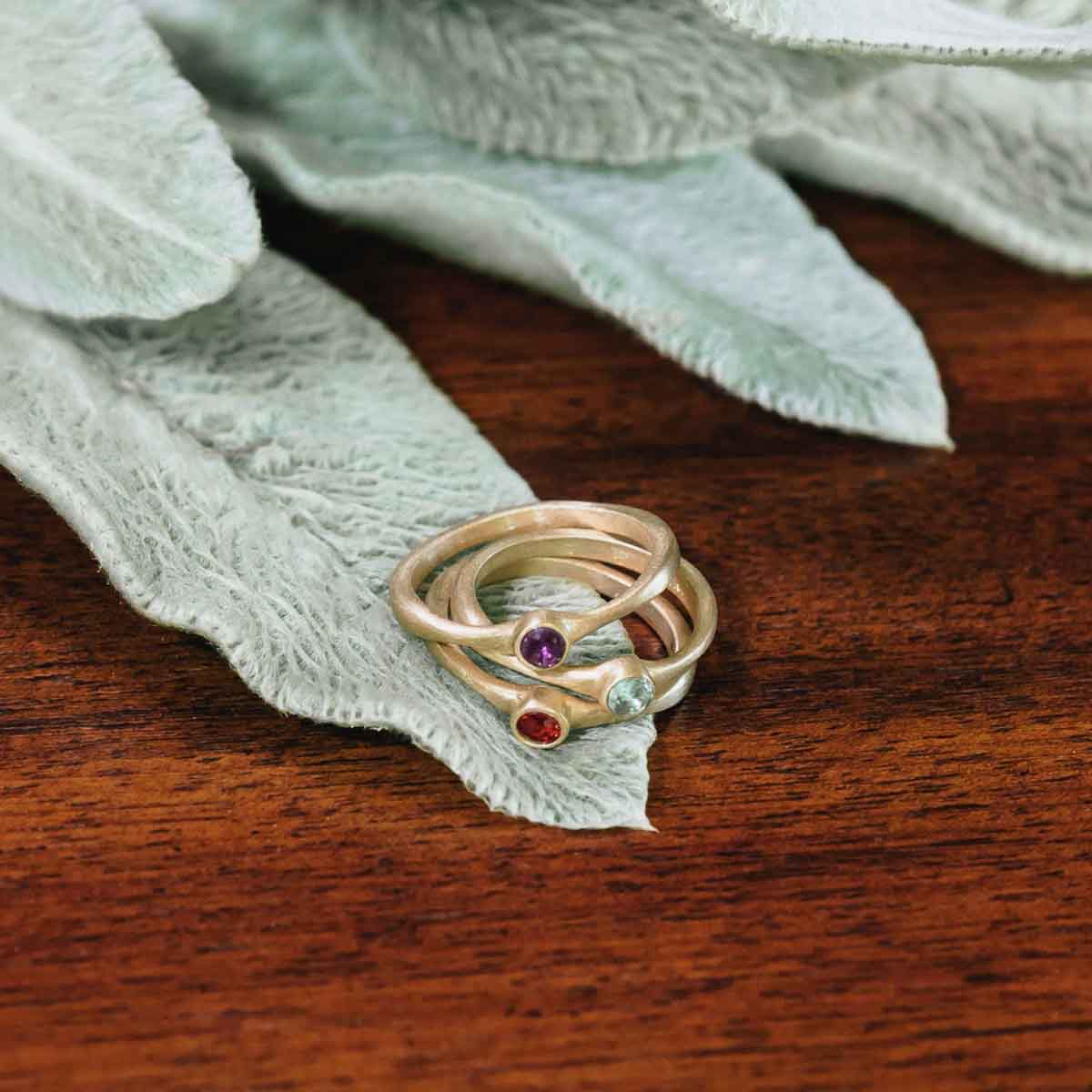 Trio of Bezel birthstone rings handcrafted in 14k yellow gold set with a 3mm birthstone inside a gold bezel