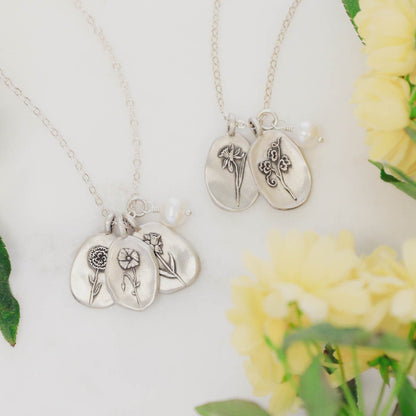 birth flower charms necklace handcrafted in sterling silver with a special birth month charm strung with a vintage freshwater pearl