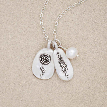 birth flower charms necklace handcrafted in sterling silver with a special birth month charm strung with a vintage freshwater pearl