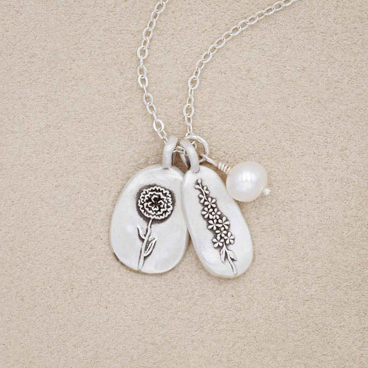 birth flower charms necklace handcrafted in sterling silver with a special birth month charm strung with a vintage freshwater pearl