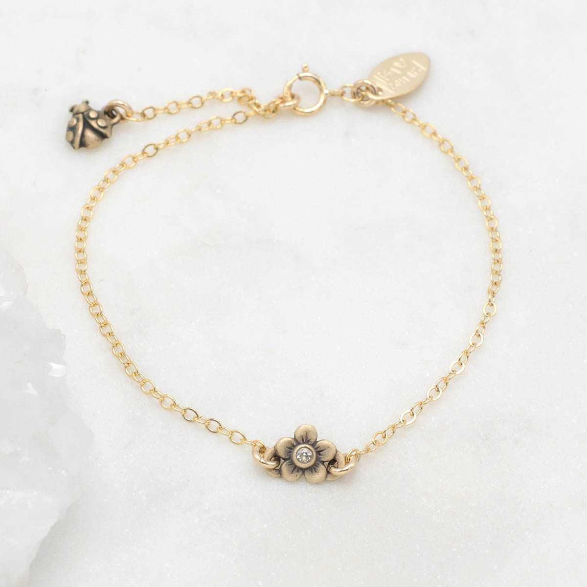 10k gold birthstone bloom bracelet with sweet flower charm and 10k yellow gold lady bug charm