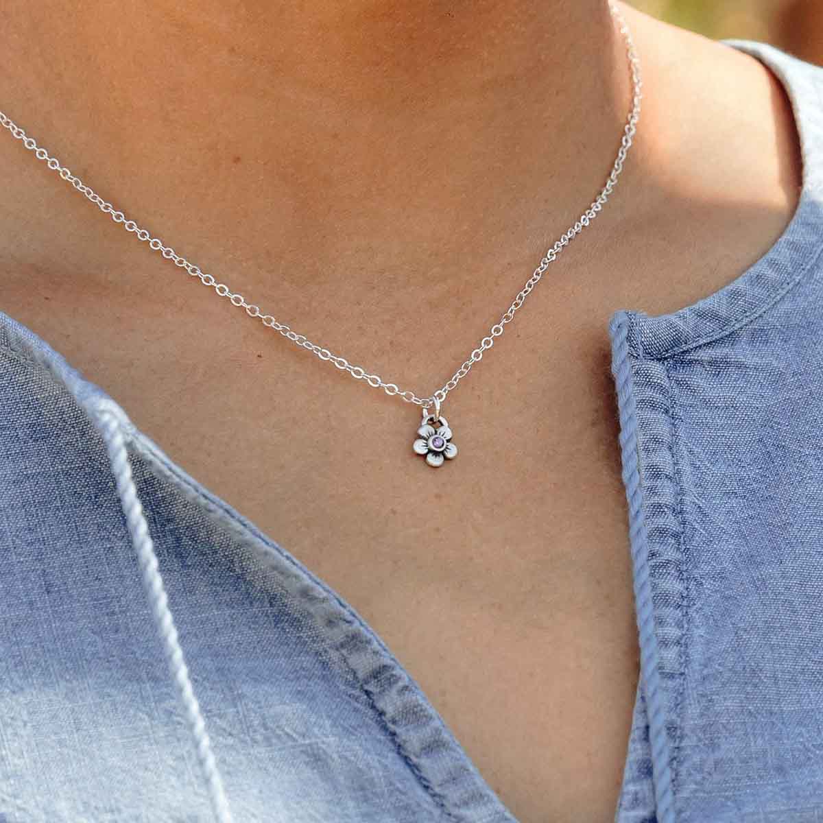 girl wearing sterling silver birthstone bloom necklace with flower charms containing 2mm genuine birthstones 