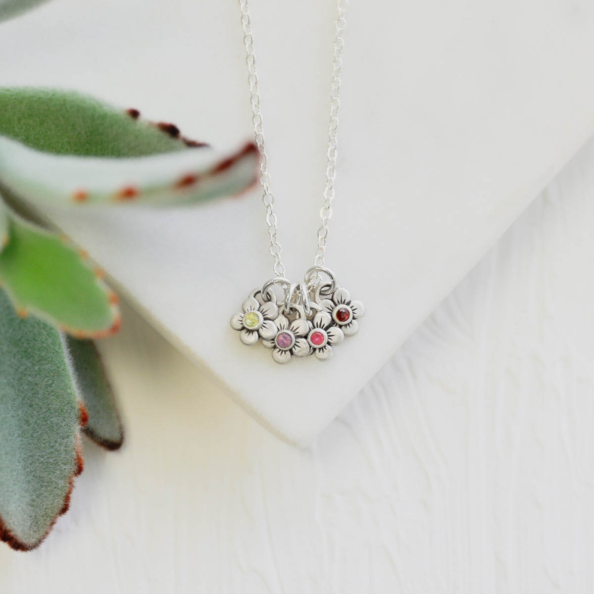 sterling silver birthstone bloom necklace with four flower charms containing 2mm genuine birthstones 