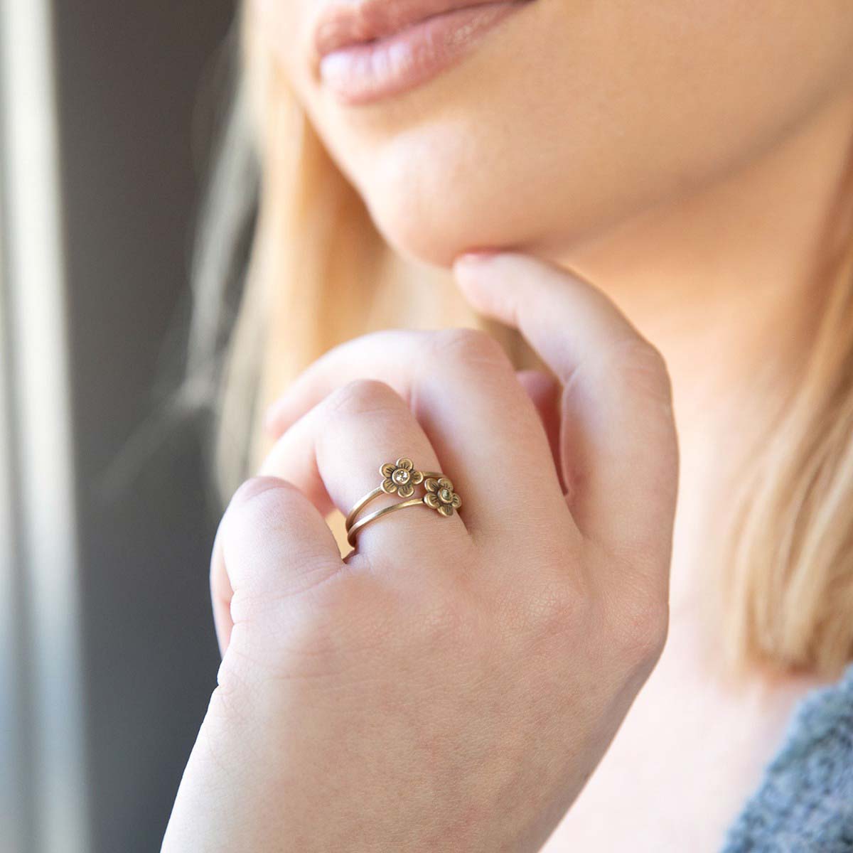 Girl wearing Birthstone bloom ring  handcrafted in 10k yellow gold with an antiqued/satin finish set with a 2mm birthstone