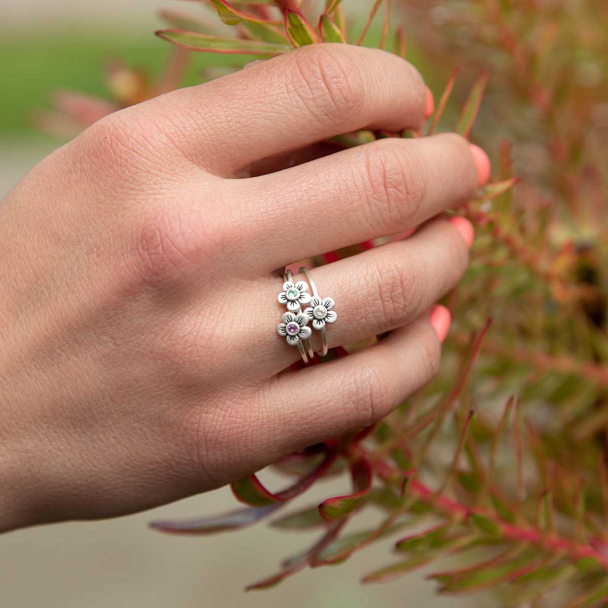 Girl wearing Birthstone bloom ring  handcrafted in sterling silver with an antiqued/satin finish set with a 2mm birthstone