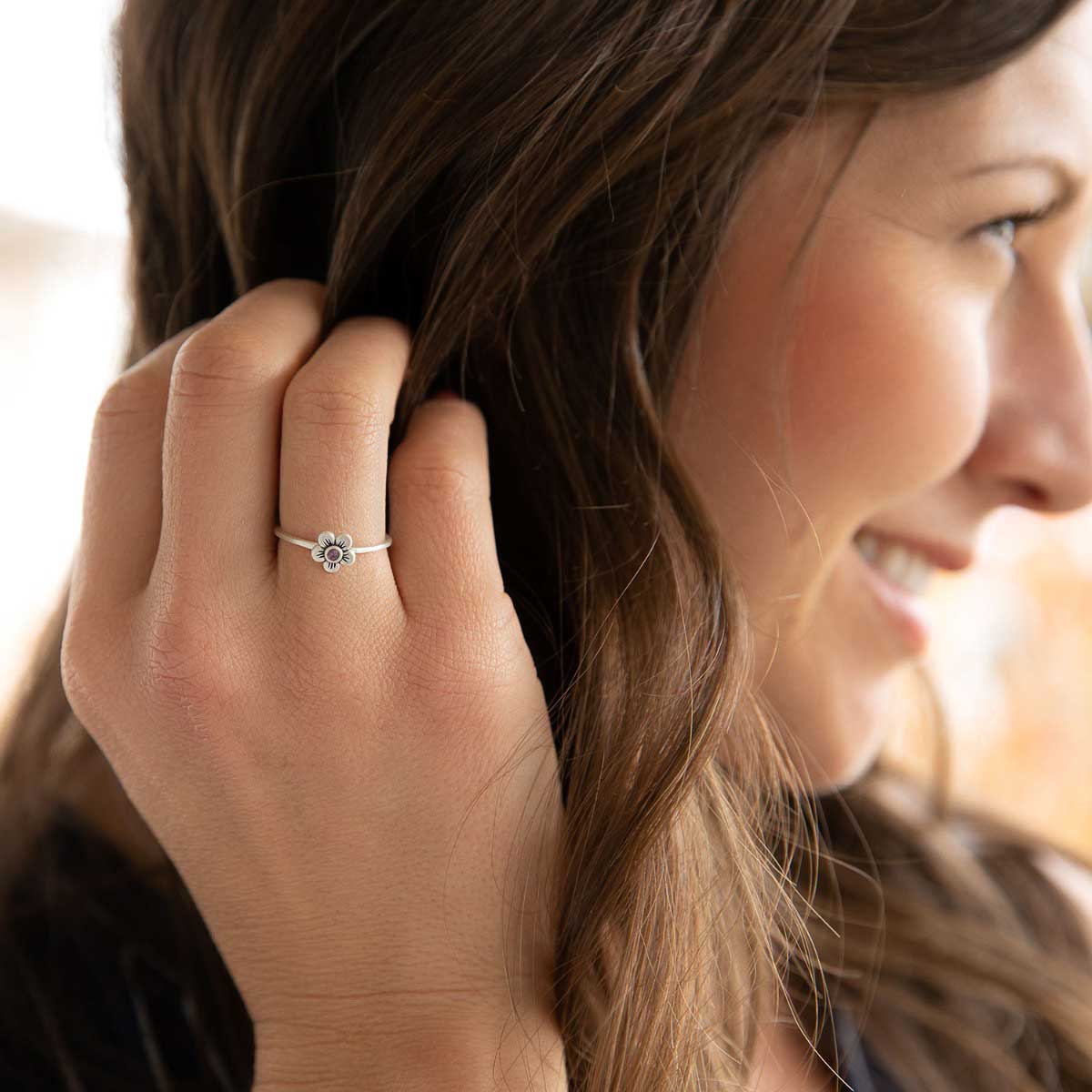 Girl wearing Birthstone bloom ring  handcrafted in sterling silver with an antiqued/satin finish set with a 2mm birthstone