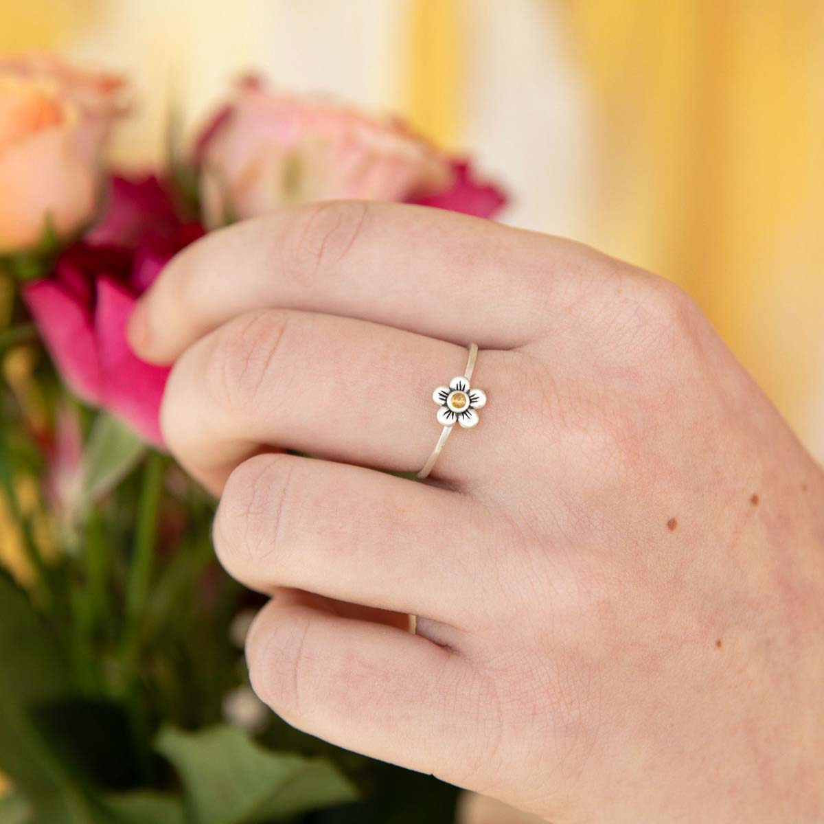 Girl wearing Birthstone bloom ring  handcrafted in sterling silver with an antiqued/satin finish set with a 2mm birthstone